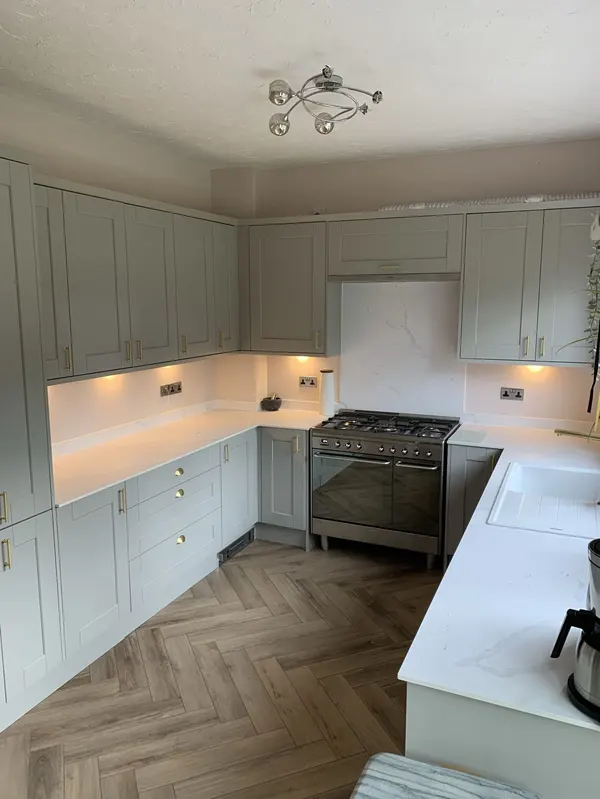 Cream shaker kitchen with metro tile splashback and herringbone flooring fitted in Blackpool